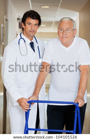 Young handsome doctor helping an old man with his walker
