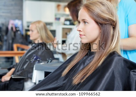 Beautiful young woman at parlor for haircut