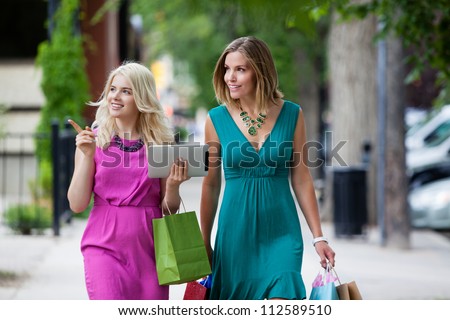 Shopping Women with Digital Tablet on street.