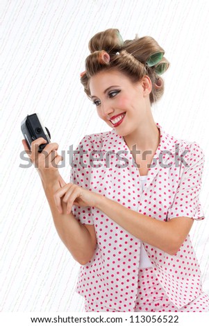 Retro styled woman taking self portrait with 35mm point and shoot camera
