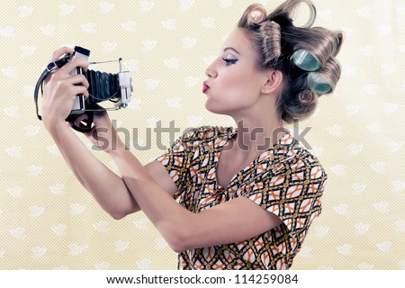 Woman taking self-portrait from vintage 4x6 film camera .