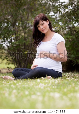 Portrait of an attractive pregnant woman in third trimester.