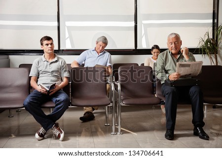 Multiethnic people waiting for the doctor in hospital lobby