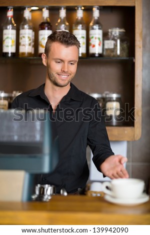 stock-photo-handsome-young-barista-gestu
