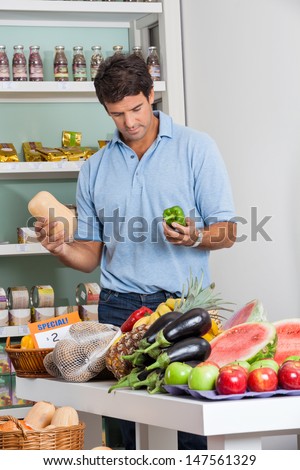 Mid adult man shopping vegetables in supermarket