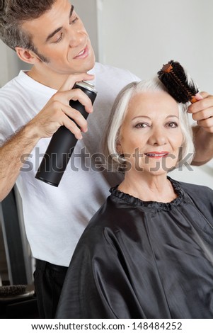 Portrait of senior woman getting her hair styled at hair salon