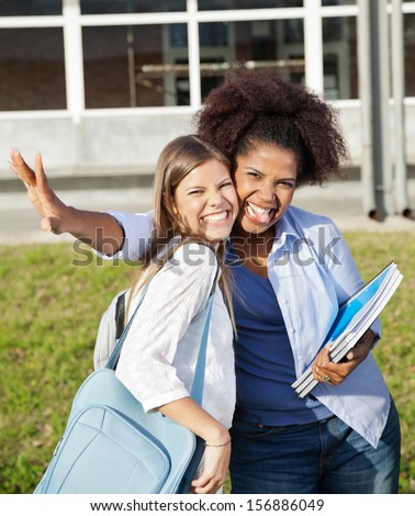 Portrait of cheerful female students making facial expressions on college campus