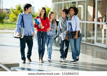 Full Length Of Cheerful University Students Walking On Campus