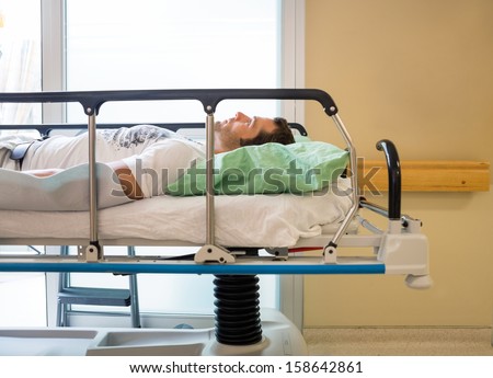 Male patient lying on bed in hospital