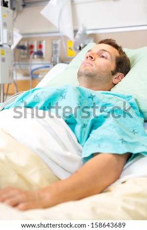 Male patient resting on bed in hospital