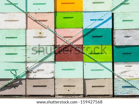 Closeup of multicolored honeycomb crates tied on truck