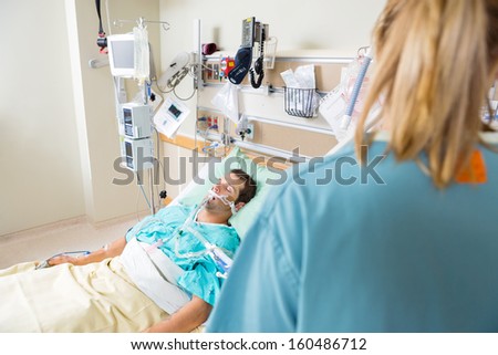 Critical male patient sleeping in hospital room