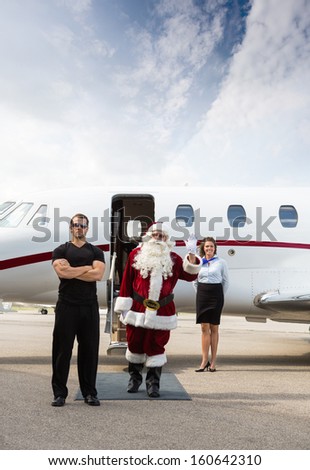 Santa exiting his modern sleigh with body guard.