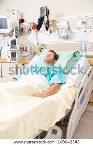 Young male patient resting on bed in hospital