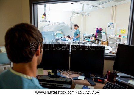 Male radiologist working in CT scan lab