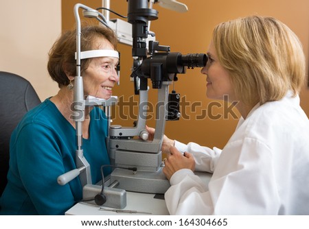 Eye Doctor Examining Senior Woman\'S Vision With Slit Lamp In Eye Clinic