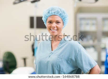 Portrait of beautiful young surgical team member standing in operating theater