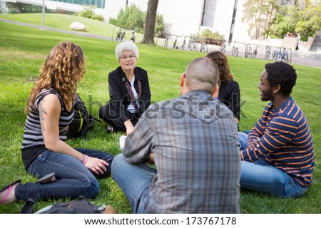 University class taking place outdoors with small group of students
