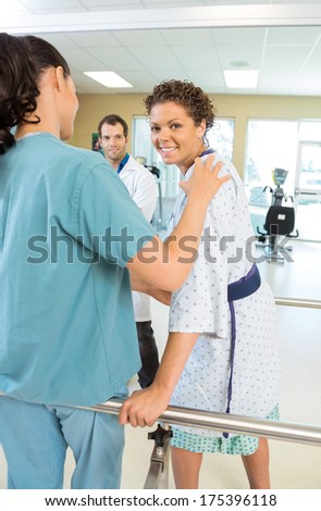 Portrait of female patient being assisted by physical therapist