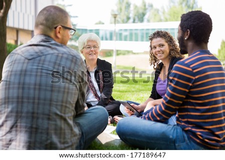 Casual study group receiving help from university professor