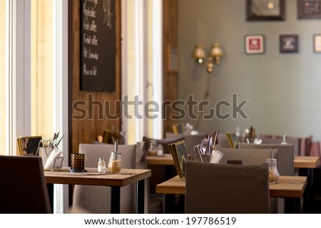 Interior of a rustic cafe with large windows