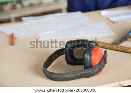 Closeup of ear protectors on wooden table in workshop