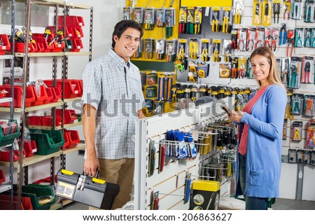 Portrait of smiling couple buying tools in hardware store