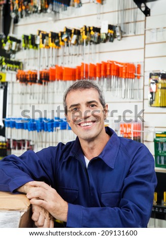 Portrait of happy mature worker in hardware shop