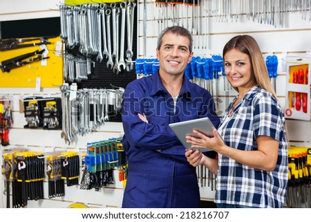 Portrait of female customer and male vendor with digital tablet in hardware store Portrait of female customer and male vendor with digital tablet in hardware store