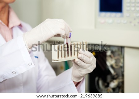 Cropped image of female medical worker analyzing blood samples in laboratory Cropped image of female medical worker analyzing blood samples in laboratory