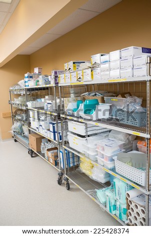 Large group of hospital supplies arranged on trollies in storage room