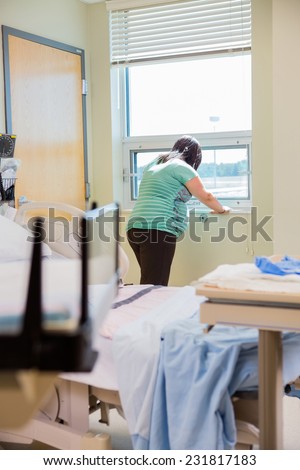 Pregnant woman in pain in hospital waiting to give birth.