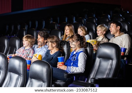 Shocked families watching movie in cinema theater