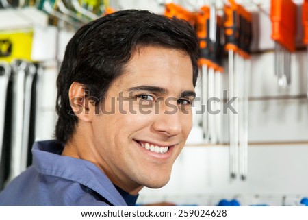 Closeup portrait of handsome man smiling in hardware shop