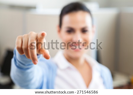 Young female customer service representative pointing at you in call center