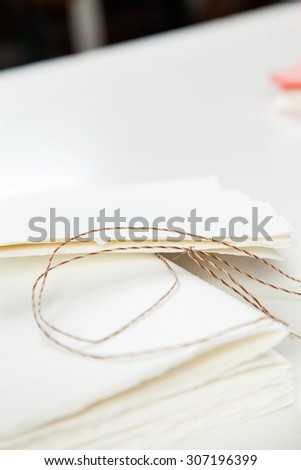 Closeup of thread and notepad papers on table
