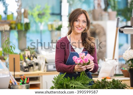 Happy Florist Making Bouquet Of Pink Roses In Shop