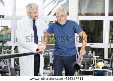 Doctor Motivating Senior Man To Walk In Fitness Studio