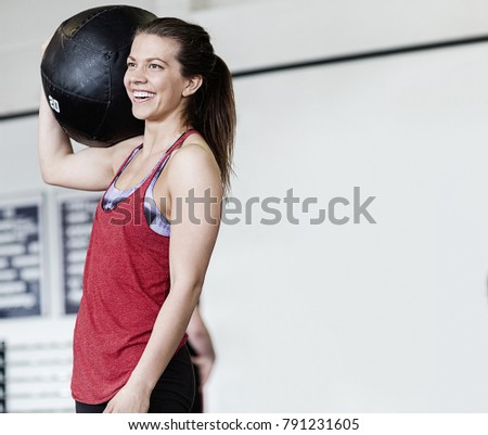 Woman With Medicine Ball On Shoulder