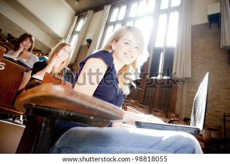 Students in a lecture hall with strong backlighting