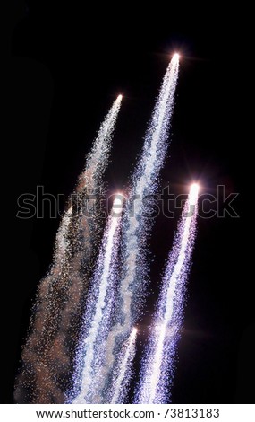 Bunch of colorful fireworks rockets fired up in the night sky