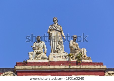 CALCUTTA, WEST BENGAL, INDIA - FEB 9, 2014 Sculptural composition Commerce on the roof of the Writers House