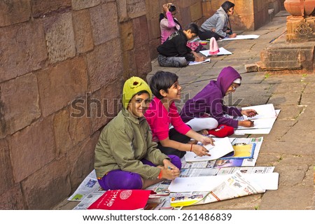 JANUARY 26, 2015, INDIA, ORISSA, BHUBANESHWAR - Indian children learns to draw close to famous Mukteshwar temple. They are copies an ancient temple carving.