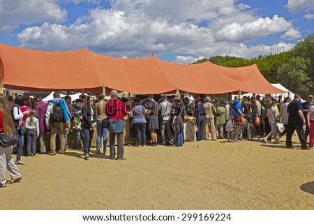 JUNE 6, 2015,  MOSCOW, RUSSIA -  Festival of the historic reconstruction Times and Ages in the park Kolomenskoye. Visitors on the souvenire market