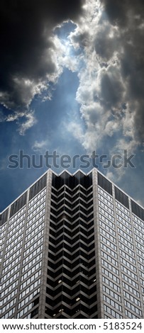 Office building with dramatic cloudy skies and lighting.