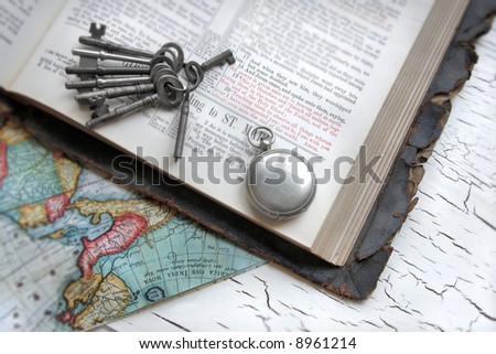 Antique Bible with keys, watch, and a map.