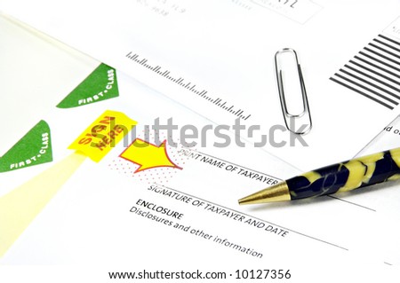 Tax Papers to sign with an antique pen and envelopes.