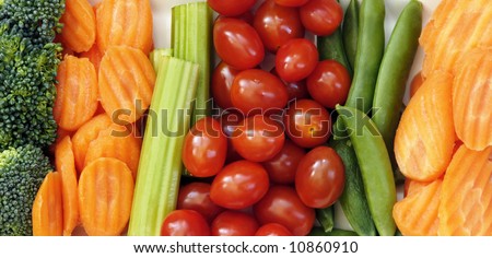 Raw vegetables to eat with dip including carrots, sugar snap peas, tomatoes, broccoli, and celery sticks.