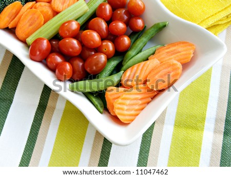 Raw vegetables to eat with dip including carrots, broccoli, and celery sticks.