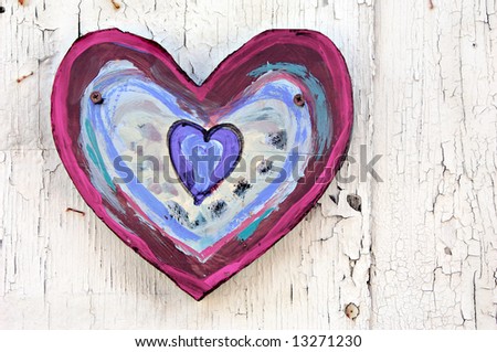 Painted heart on weathered, grungy, painted wall.